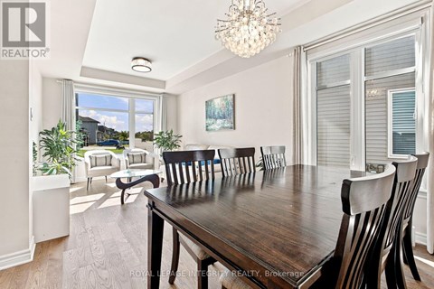 A dining room with a wooden table and chairs.