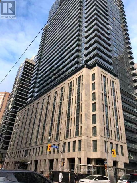 A tall building with a sign that reads AC REALTY BROUGHT IN.