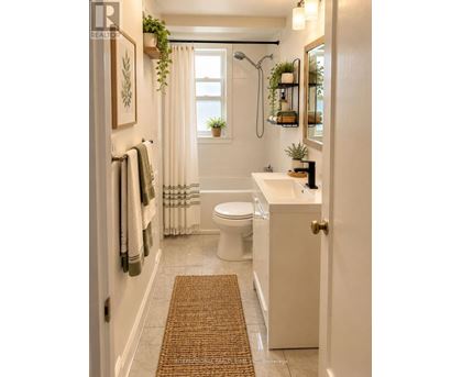 A bathroom with a toilet, sink, and shower.