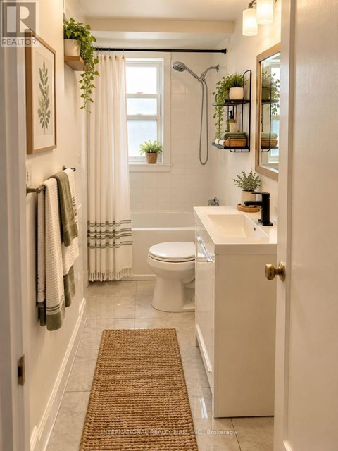 A bathroom with a toilet, sink, and shower.