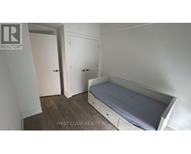 A bedroom with a bed, wardrobe and cupboard.