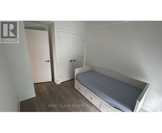 A bedroom with a bed, wardrobe and cupboard.