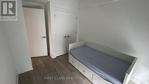 A bedroom with a bed, wardrobe and cupboard.