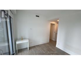 A room with a white bench and a door in the background.