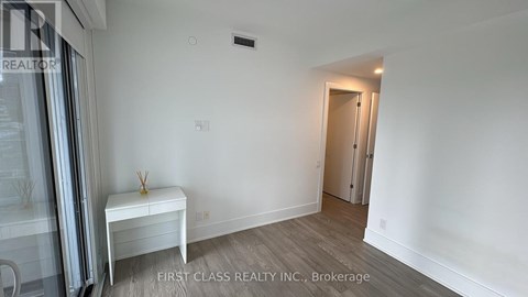 A room with a white bench and a door in the background.