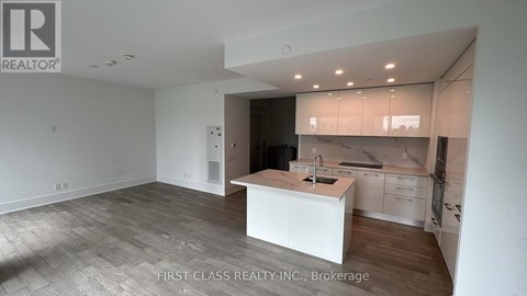 A kitchen area with a sink and cabinets.