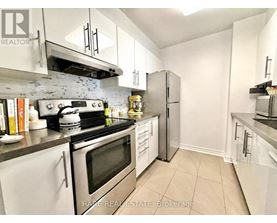 A kitchen with white cabinets and stainless steel appliances.