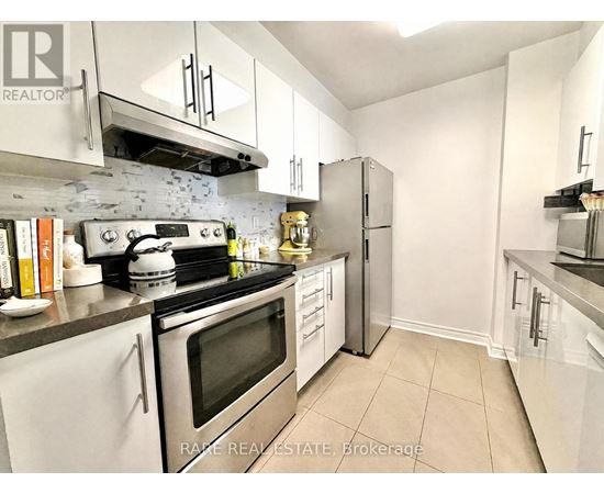 A kitchen with white cabinets and stainless steel appliances.