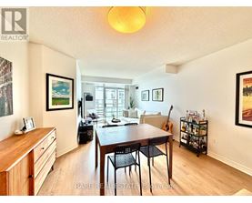 A dining room with a wooden table and chairs.