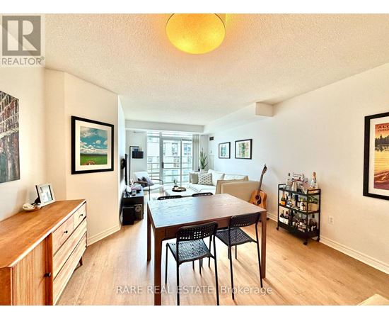 A dining room with a wooden table and chairs.