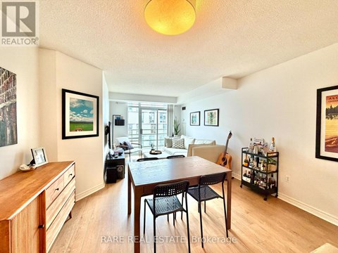 A dining room with a wooden table and chairs.