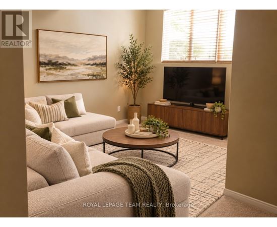 A living room with a couch, a coffee table, a television, and a plant.