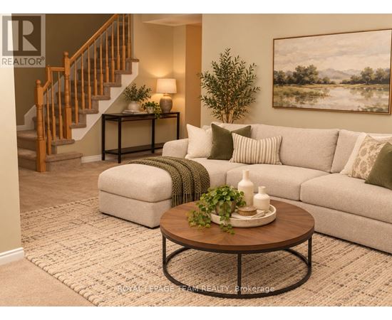 A living room with a couch, coffee table, and a painting on the wall.