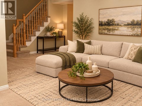 A living room with a couch, coffee table, and a painting on the wall.
