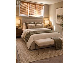 A bedroom with a large bed and a green throw blanket.
