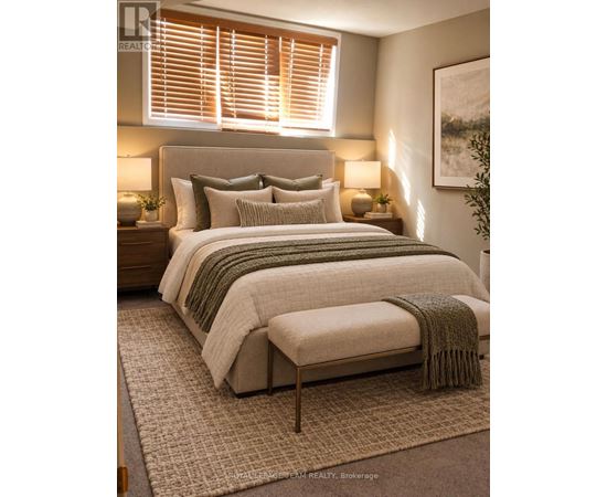 A bedroom with a large bed and a green throw blanket.
