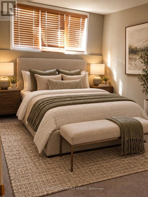 A bedroom with a large bed and a green throw blanket.