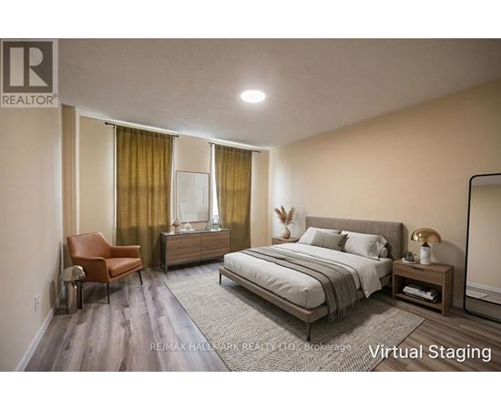 A bedroom with a bed, chair, and nightstand.