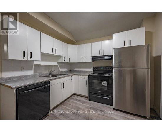 A kitchen with white cabinets and stainless steel appliances.