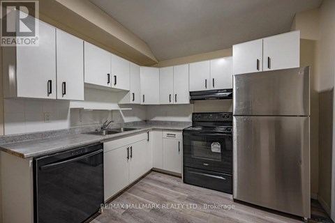 A kitchen with white cabinets and stainless steel appliances.