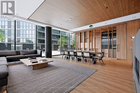 A living room with a couch, chairs, and a coffee table.