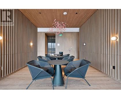 A modern dining area with a round table and chairs.