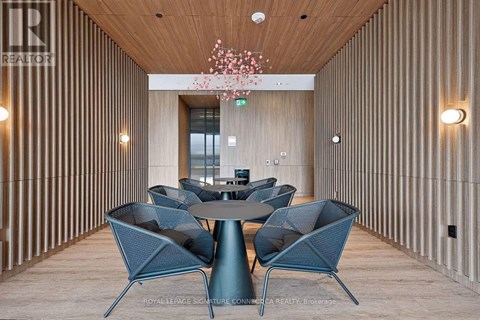 A modern dining area with a round table and chairs.