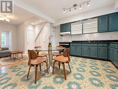 A dining room with a glass table and chairs.