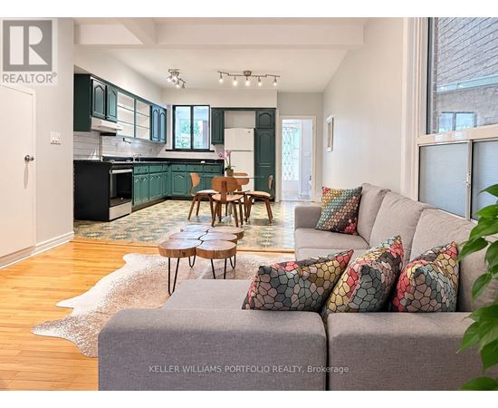 A living room with a grey couch and a wooden table.