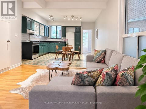 A living room with a grey couch and a wooden table.