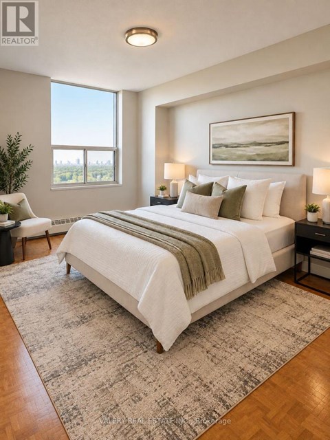 A bedroom with a large bed and a painting on the wall.