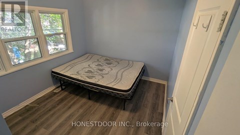A bedroom with a bed and a window.