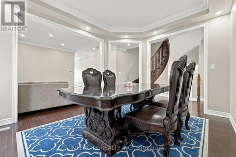 A dining room with a table and chairs.