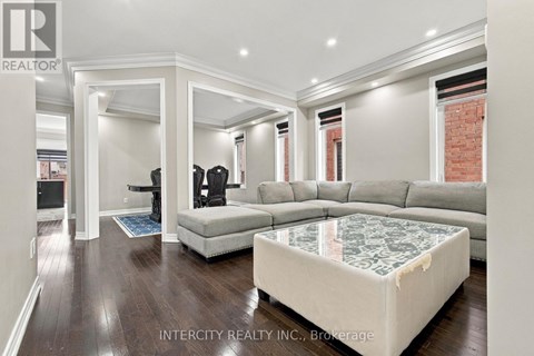 A living room with a grey sofa and a glass coffee table.