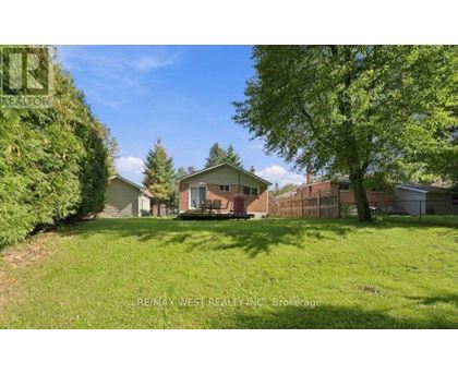 A house with a yard is for sale by RE/MAX West Realty Inc.