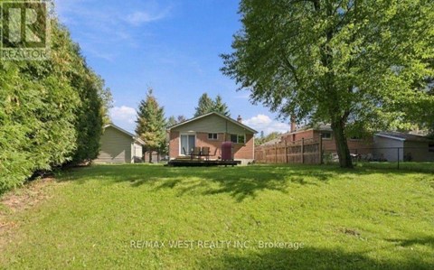 A house with a yard is for sale by RE/MAX West Realty Inc.