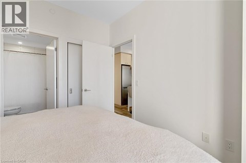 A bedroom with a large bed and a bathtub in the bathroom.