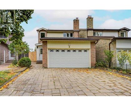 A house with a brick facade and a white garage door.