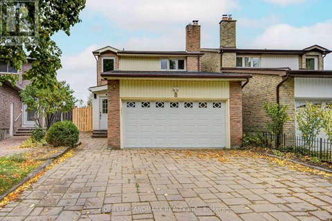 A house with a brick facade and a white garage door.
