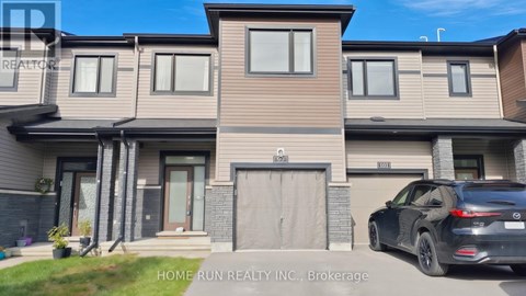 A modern house with a black car parked in front.