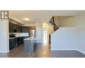A spacious kitchen with dark wood cabinets and a white island.