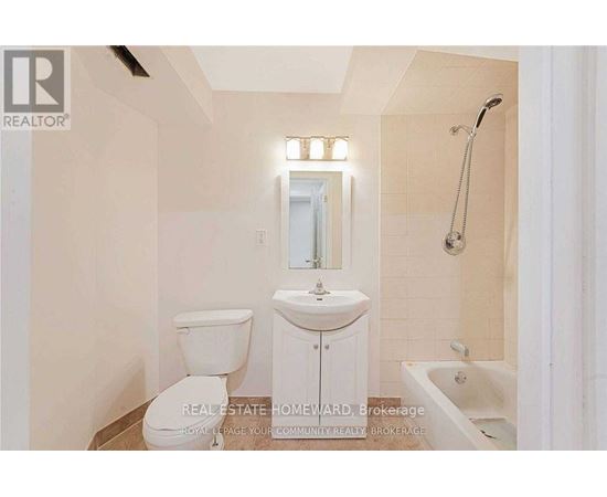 A white bathroom with a toilet, sink, and bathtub.