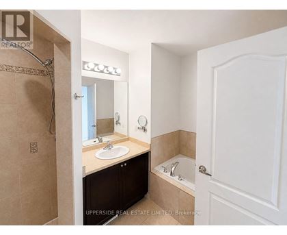 A bathroom with a sink, mirror, and bathtub.