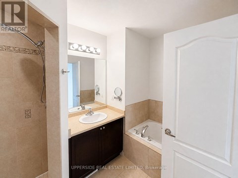 A bathroom with a sink, mirror, and bathtub.