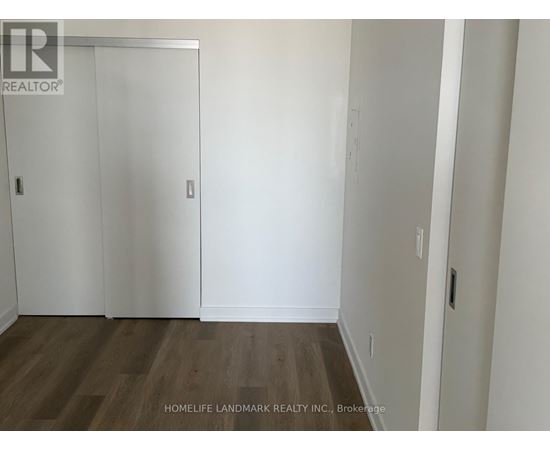 A room with a wooden floor and white walls.