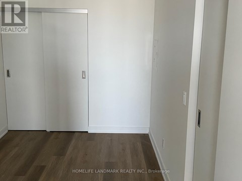 A room with a wooden floor and white walls.