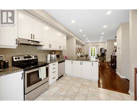 A kitchen with white cabinets and a stove top oven.