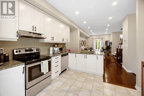 A kitchen with white cabinets and a stove top oven.