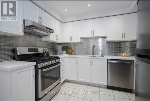 A modern kitchen with white cabinets and a stainless steel dishwasher.