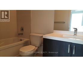 A bathroom with a toilet, sink, and bathtub.